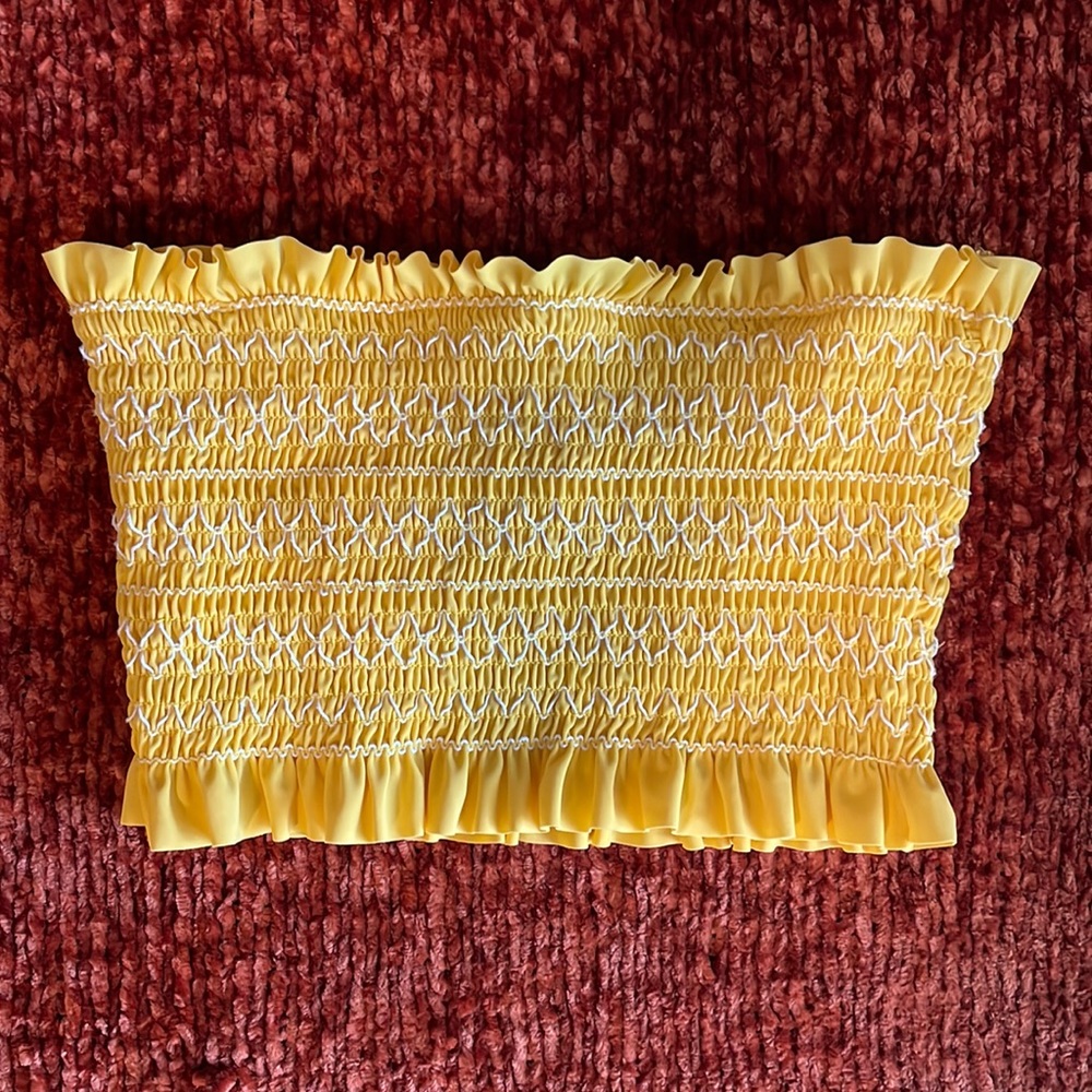 Medium yellow strapless bathing suit top.